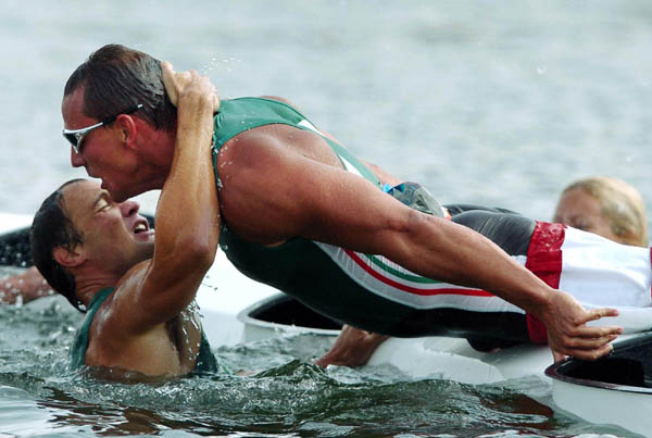 Hungary's Botond Storcz (top) and team mate Akos Vereckei celebrate their teams gold medal win of the K4 1000m final during the Athens 2004 Summer Olympic Games on Friday, August 27, 2004. Canada's team came in ninth.  (CP PHOTO/COC-Andre Forget)