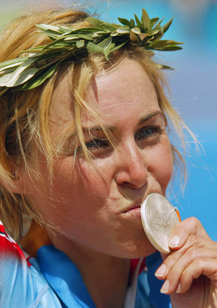 Canada's Marie-Helene Premont of Chateau-Richer, Que. kisses her silver medal in women's mountain bike action at the Athens Olympics, Friday, August 27, 2004.(CP PHOTO/COC-Mike Ridewood)