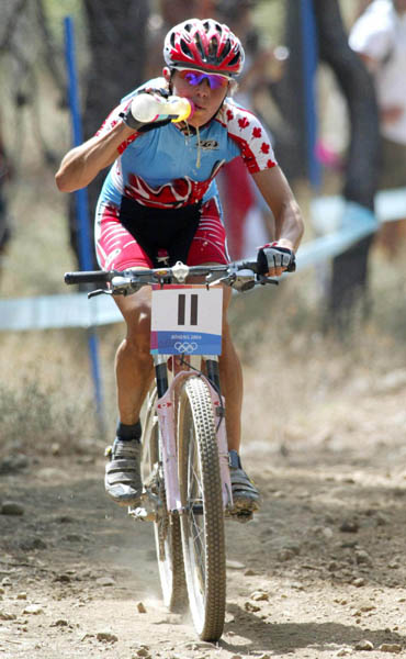 Canada's Marie-Helene Premont of Chateau-Richer, Que. takes on water on her way to the silver medal in women's mountain bike at the Athens Olympics, Friday, August 27, 2004.(CP PHOTO/COC-Mike Ridewood)