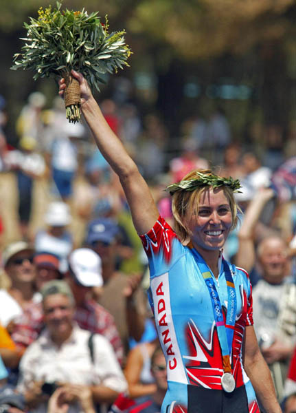 Canada's Marie-Helene Premont of Chateau-Richer, Que. waves to the crowd after receiving her silver medal in women's mountain bike at the Athens Olympics, Friday, August 27, 2004.(CP PHOTO/COC-Mike Ridewood)