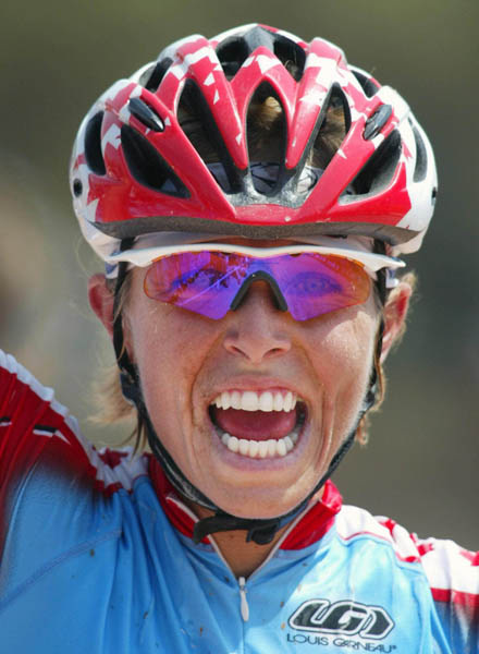Canada's Marie-Helene Premont, of Chateau-Richer, Que. celebrates as she crosses the finish line to take the silver medal in women's mountain bike action at the Athens Olympics, Friday, August 27, 2004.(CP PHOTO/COC-Mike Ridewood)