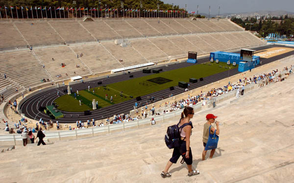 People walk in the stands as archers compete at the Panathinaiko Stadium of during the Athens 2004 Summer Olympic Games August 15, 2004. Attendance at the Athens Olympics has been disappointing during the first two days but organisers said on Sunday they hope ticket sales will pick up soon. (CP PHOTO/COC-Andre Forget)