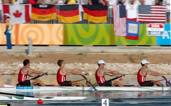 Canada's mens lightweight four cruise past spectators during the lightweight four final of the Athens 2004 Summer Olympic Games Sunday, August 22, 2004. They went on to place forth. (CP PHOTO 2004/Andre Forget/COC)