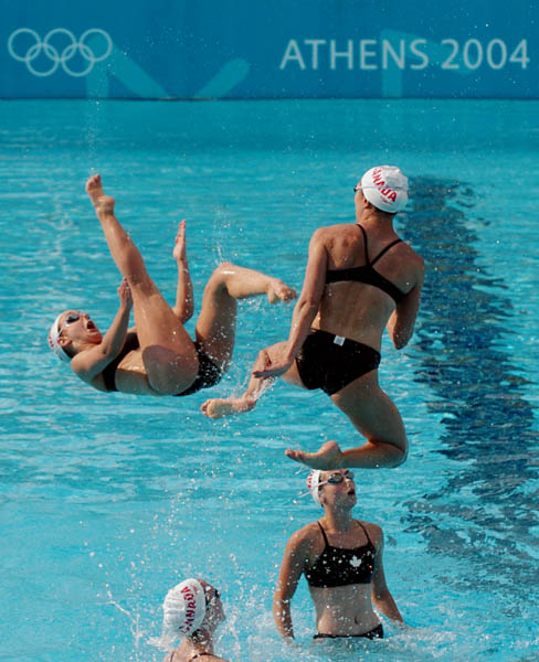 Canadian Scynco team member's appear to collide as they fly through the air during the Athens 2004 Summer Olympic Games August 10 2004 in Greece. (CP PHOTO 2004/Andre Forget/COC)