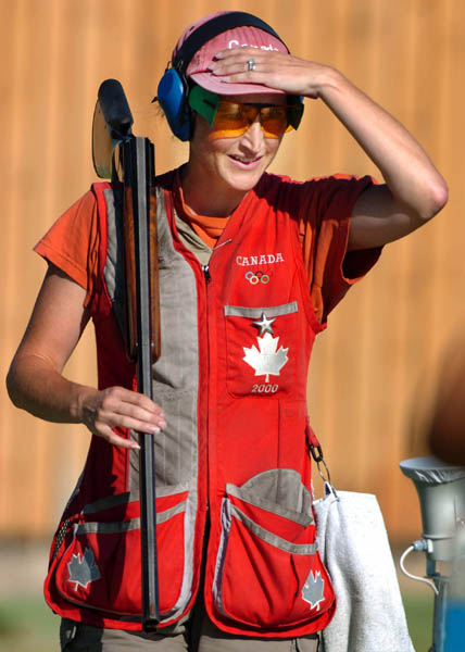 Cynthia Meyer of Bowen Island, B.C.shields her eyes from the sun during the qualification round of the Double Trap event of the Athens 2004 Summer Olympic Games Wednesday August 18, 2004. Meyer did not advance.  (CP PHOTO/COC-Andre Forget)