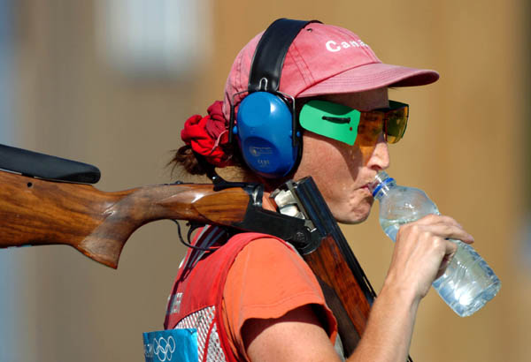 Cynthia Meyer of Bowen Island, B.C. takes a drink of water during the qualification round of the Double Trap event of the Athens 2004 Summer Olympic Games Wednesday August 18, 2004. Meyer did not advance.  (CP PHOTO/COC-Andre Forget)