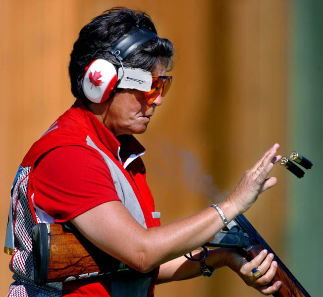 Susan Nattrass of Edmonton, Alberta removes the spent shells of her shotgun during the Qualification round of the Double Trap event of the Athens 2004 Summer Olympic Games Wednesday August 18, 2004. Nattrass did not advance. (CP PHOTO/COC-Andre Forget)