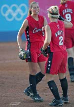 Erin White of Richmond, B.C. and Rachel Schill of Kitchener, Ont. celebrate the Canadian women's softball team victory over Taiwan 2 - 0 at the Athens Olympics, Saturday, August 14, 2004.  (CP PHOTO/COC-Mike Ridewood)