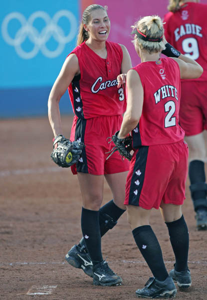 Pitcher Lauren Bay of Trail, B.C. celebrates the Canadian women's softball team 2 - 0 shutout of Taiwan with teammate Erin White of Richmond, B.C., at the Athens Olympics, Saturday, August 14, 2004.  (CP PHOTO/COC-Mike Ridewood)
