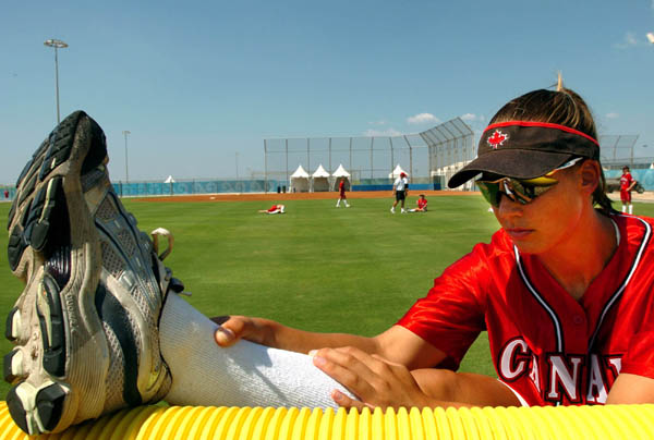 Canadian Womens's Olympic Softball Team member Auburn Sigurdson stretches during practice prior to the Athens 2004 Summer Olympic Games August 11, 2004. (CP PHOTO 2004/Andre Forget/COC)
