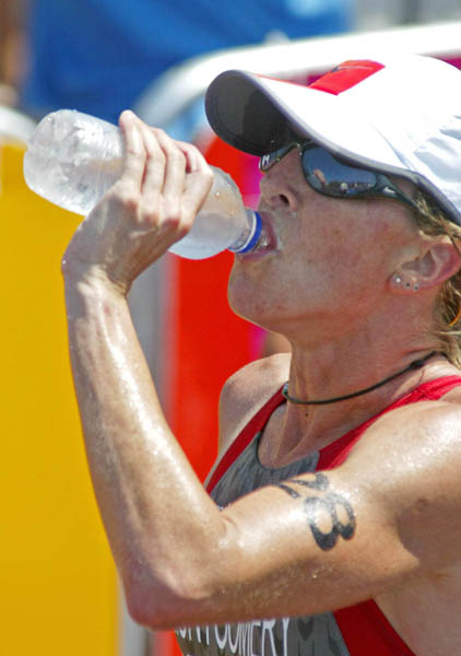 Canada's Carol Montgomery of Vancouver takes on water after finishing 35th in women's triathlon at the Athens Olympics, Wednesday, August 25, 2004. (CP PHOTO/COC-Mike Ridewood)