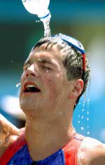 Canada's Simon Whitfield of Victoria, B.C., celebrates with the gold medal winner New Zealand's Hamish Carter after the Triathlon event at  the Athens 2004 Summer Olympic Games Thursday August 26, 2004. (CP PHOTO/COC-Andre Forget)
