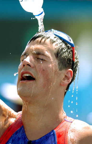 Andy Potts of the U.S. pours water over his face after running in the Triathlon event at  the Athens 2004 Summer Olympic Games Thursday August 26, 2004. Potts came in 22nd. (CP PHOTO/COC-Andre Forget)