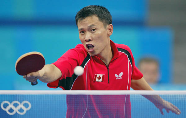 Canada's Johnny Huang of Toronto hits a shot during his loss to Aleksandar Karakasevic of Serbia and Montenegro in men's table tennis at the Summer Olympics in Athens, Greece,  Monday, August 16, 2004.  (CP PHOTO/COC/Mike Ridewood)
