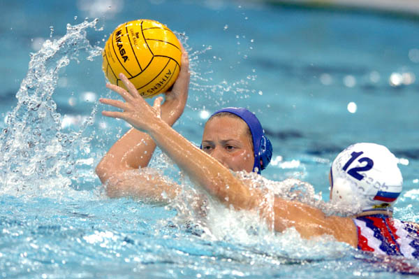 Canadian Susan Gardiner goes to make a pass as Russian Ekaterina Vasilieva tries to block during Waterpolo action against Russia during the Athens 2004 Summer Olympic Games August 16, 2004. (CP PHOTO 2004/Andre Forget/COC)