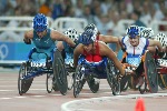 Canada's Chantal Petitclerc (right) of Montreal duels with Eliza Stankovich of Australia on her way to the gold medal in women's wheelchair 800 metres in track and field action at the Athens Olympics, Sunday, August 22, 2004.(CP PHOTO/COC-Mike Ridewood)