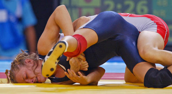 Canada's Lyndsay Belisle (left) of Burnaby, B.C., wrestles Chiharu Icho of Japan in the first match of women's 48kg. at the Athens Olympics Sunday, August 22, 2004.  Belisle lost the match. (CP PHOTO)2004(COC-Mike Ridewood)