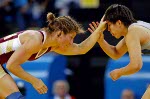 Canada's Viola Yanik (right) of Saskatoon wrestles Lili Meng of China in the first match of women's 63kg. at the Athens Olympics Sunday, August 22, 2004. Yanik lost the match. (CP PHOTO/COC-Mike Ridewood)