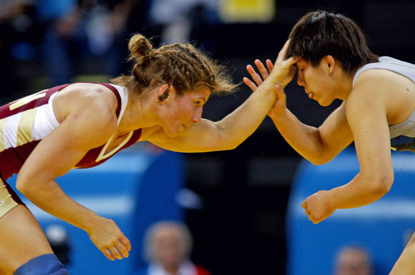 Canada's Tonya Verbeek of Beamsville, Ont., (left) fights Saori Yoshida of Japan at 55 kg. in women's wrestling finals at the Athens Olympics, Monday, August 23, 2004. Verbeek lost the match and claimed the silver medal. (CP PHOTO)2004(COC-Mike Ridewood)