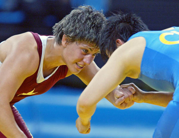 Canada's Viola Yanik (left) of Saskatoon wrestles Lili Meng of China in the first match of women's 63kg. at the Athens Olympics Sunday, August 22, 2004. Yanik lost the match. (CP PHOTO/COC-Mike Ridewood)