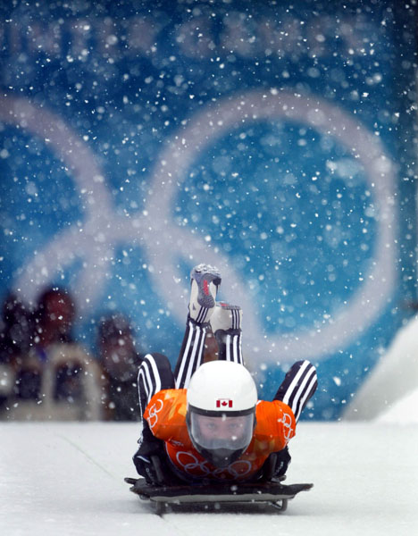 Canadian women's skeleton rider Lindsay Alcock of Calgary jumps onto her sled as she slides down the track during competition Wednesday Feb. 20, at the 2002 Olympic Winter Games in Salt Lake City. (CP Photo/COA/Andre Forget).