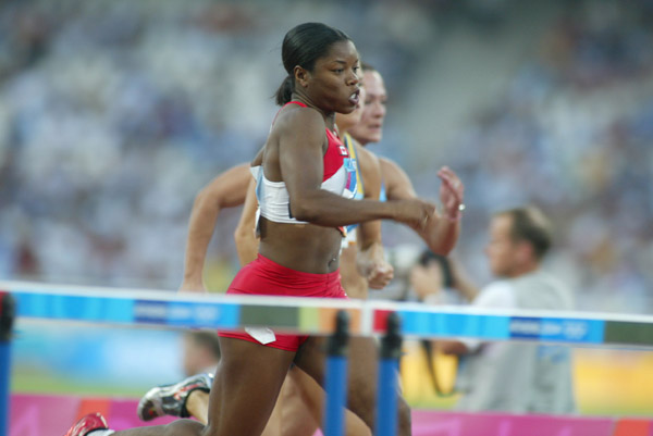 Canada's Perdita Felicien of Pickering, Ont. was second in her heat of women's 100 metre hurdles in track and field action at the Athens Olympics, Sunday, August 22, 2004.(CP PHOTO/COC-Mike Ridewood)