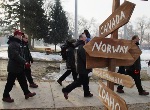 Canadian athletes pass by a a sign post pointing the direction to other countries prior to the Canadian flag raising at the Olympic Village in Salt Lake City, Utah Thursday Feb. 7, 2002. (CP PHOTO/HO/COA/Andre Forget)