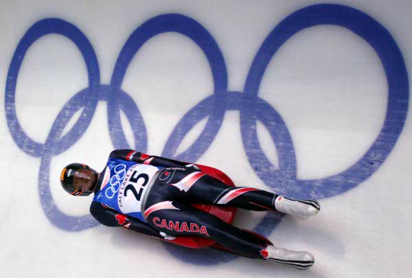Canadian Tyler Seitz slides down the track during Men's Singles in Park City, Utah Sunday Feb. 10, 2002 at the Salt Lake City Winter Olympic Games. (CP Photo/HO/COA/Andre Forget)