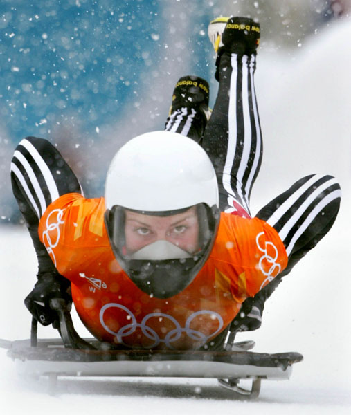 Canadian women's skeleton rider Michelle Kelly jumps onto her sled as she slides down the track during competition Wednesday Feb. 20, at the 2002 Olympic Winter Games in Salt Lake City. (CP Photo/COA/Andre Forget).