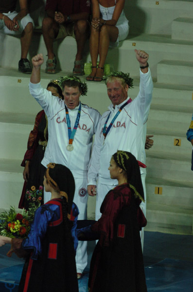 Canada's Ross MacDonald (left) of Vancouver, BC, and Mike Wolfs (right) of Port Credit, Ontario, wave to the crowd after receiving their silver medal won in the star sailing event at the 2004 Summer Olympic Games in Athens on Saturday August 28, 2004. (CP PHOTO 2004/Andre Forget/COC)