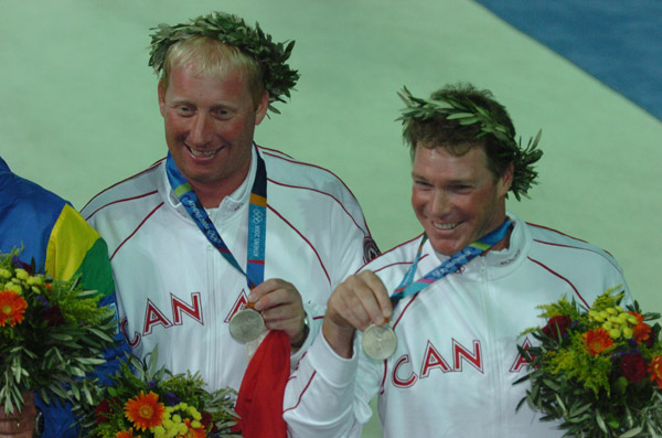Canada's Ross MacDonald (right) of Vancouver, BC, and Mike Wolfs (gauche) of Port Credit, Ontario, show their silver medal in the star sailing event at the 2004 Summer Olympic Games in Athens on Saturday August 28, 2004. (CP PHOTO 2004/Andre Forget/COC)