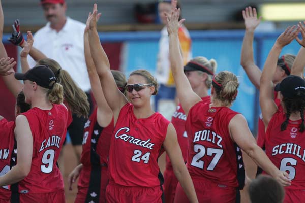 Canada's Cindy Eadie (#9), Auburn Sigurdson (#24), Kaila Holtz (#27), and Rachel Schill (#6) celebrate with other teammates their win against Taipei in the preliminary game in the softball tournament on August 14, 2004 at the Olympic Games in Athens. (CP PHOTO)2004(COC-Mike Ridewood)