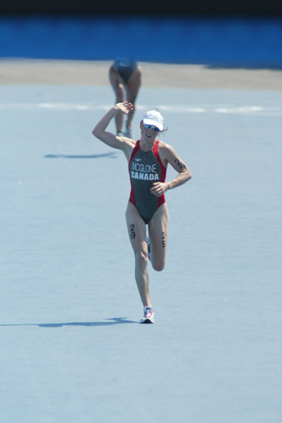 Canada's Samantha McGlone of Montreal, Quebec, crosses the finish line 27th in the women's triathlon at the Summer Olympic Games in Athens, Greece, on Wednesday Aug 25, 2004. (CP PHOTO/COC-Mike Ridewood)