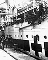 Photograph of a hospital ship being welcomed in Halifax as veterans unload, circa 1918-1925