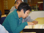 Photograph of Corenna Nuyalia (front) from Iqaluit (formerly Frobisher Bay) and Thomas Aggark (back) of Arviat (formerly Eskimo Point), students from Nunavut Sivuniksavut Training Program, seaching the card catalogues at Library and Archives Canada, Ottawa, October 2005
