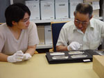Photograph of Sylvia Ivalu and Elder Louis Uttak from Igloolik (Iglulik), Nunavut, looking through a photographic album depicting Inuit, in the collections of Library and Archives Canada, Ottawa, October 2005