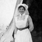 Full length photograph of Ruby Peterkin in uniform standing just outside her tent