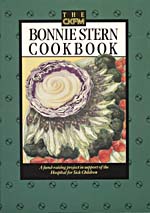 Cover of cookbook, BONNIE STERN'S ESSENTIALS OF HOME COOKING, with an illustration of an onion, purple cabbage, broccoli, carrots and other vegetables arranged in the shape of a flower