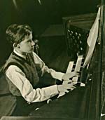 Photograph of Glenn Gould playing the organ in the concert hall of the Toronto Conservatory of Music, c. 1945