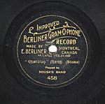 Label of a seven-inch black disc, with gold scroll lettering and foliate lines separating the words, circa 1901