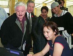 Photo of Nunavut Commissioner Peter Irniq and National Archivist Ian E. Wilson watching as Elisapee Avingaq of Igloolik (Iglulik) demonstrates the use of the laptop computer at the Project Naming event in Ottawa.