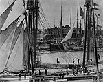 Photograph of sailing vessels awaiting lockage in old Welland Ship Canal, circa 1890-1900