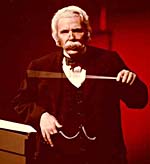 Photograph of Glenn Gould, as Sir Nigel Twitt-Thornwaite, holding baton, 1980